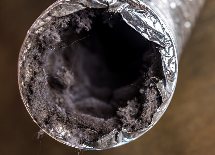 Technician cleaning a dryer vent to prevent fire hazards and improve airflow. Regular dryer vent cleaning is essential for HVAC maintenance, including furnace repair and aeroseal duct sealing. It helps ensure the efficient operation of the entire HVAC system, including air conditioning and heating systems. Proper dryer vent cleaning can significantly reduce energy costs, prevent costly repairs, and enhance the overall air quality in your home. It's part of maintaining optimal heating and cooling performance, improving indoor air quality, and reducing the risk of damage to HVAC equipment.