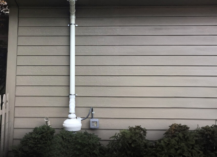 A technician performing radon mitigation using advanced radon systems to ensure the indoor air quality. The image shows the use of a laser measuring device, essential for precise installation in aeroseal duct sealing to prevent leaks. This system also complements HVAC services, improving overall heating and cooling efficiency. Air quality testing is vital for detecting radon levels and other pollutants, while also addressing furnace repair, boiler repair, and AC repair to create a healthier environment for homeowners.