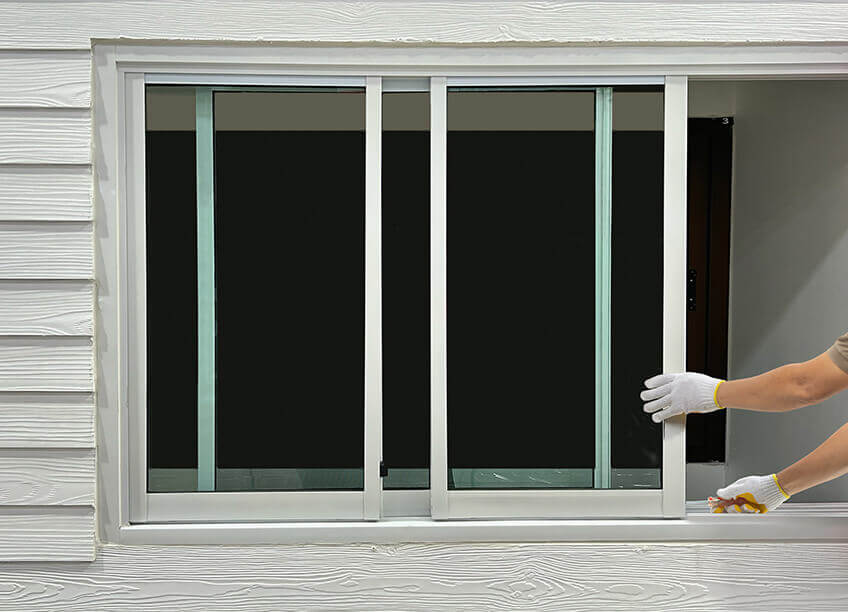 A person repairing a door handle, illustrating the importance of handyman services for home maintenance. This image represents services like door repair, along with HVAC installation, furnace replacement, and air duct cleaning. Whether it's fixing doors or improving heating and cooling systems, these tasks are essential for ensuring the safety, efficiency, and comfort of a well-maintained home.