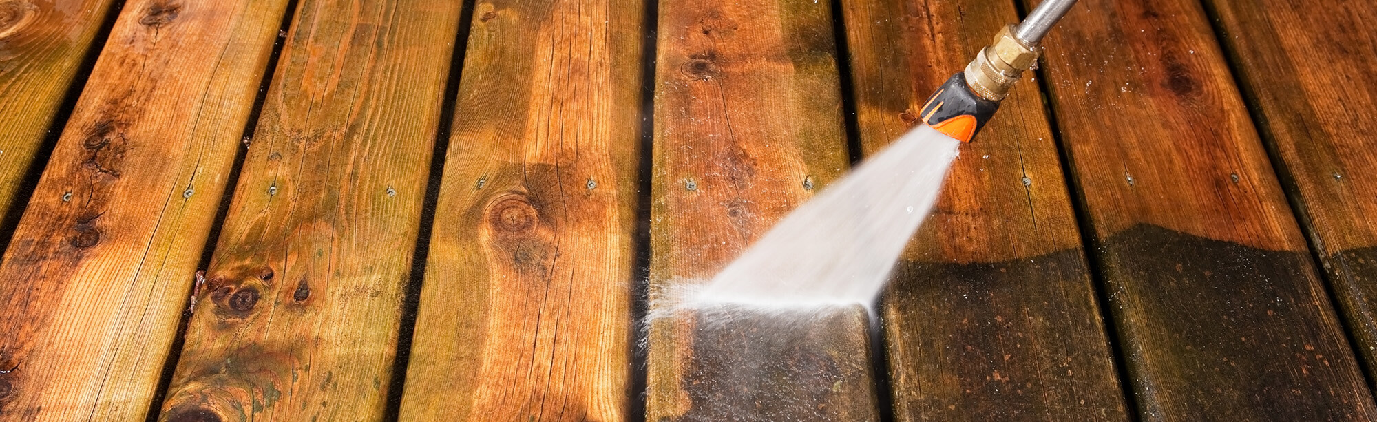 A pressure washer being used to clean a wooden deck, highlighting the importance of professional pressure washing services as part of home maintenance. This image complements handyman services such as HVAC installation, furnace replacement, and air duct cleaning. Pressure washing helps maintain the home’s exterior, ensuring the long-lasting beauty and functionality of both outdoor and indoor systems. It showcases the connection between exterior cleaning services and HVAC services that ensure the home remains comfortable and well-maintained.