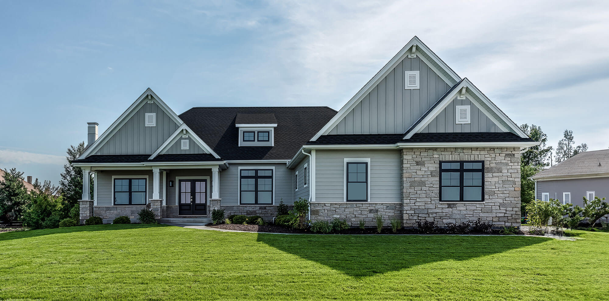 A modern home featuring a well-manicured lawn, showcasing services like HVAC repair, air duct cleaning, furnace repair, heating and cooling, HVAC installation, duct cleaning, furnace replacement, and central air installation. The home also represents HVAC contractors and electrical contractors offering services such as heating and air repair, boiler repair, ductwork, indoor air quality testing, radon mitigation, air purification system installation, dryer vent cleaning, duct sanitization, and other HVAC services to maintain optimal indoor air quality and comfort.